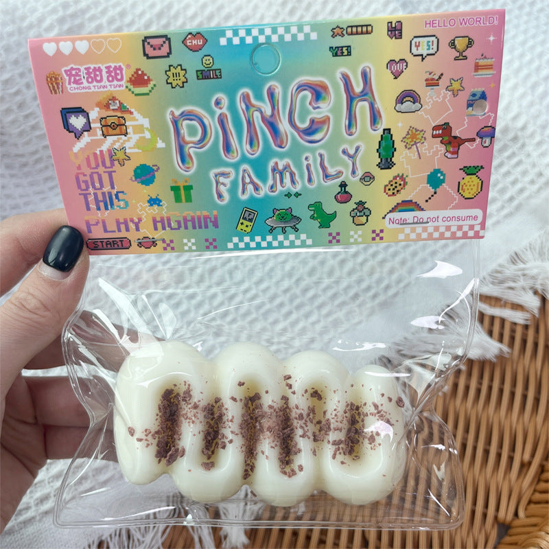 "Hand squeezing soft cream bar squishy toy showing slow rebound effect"