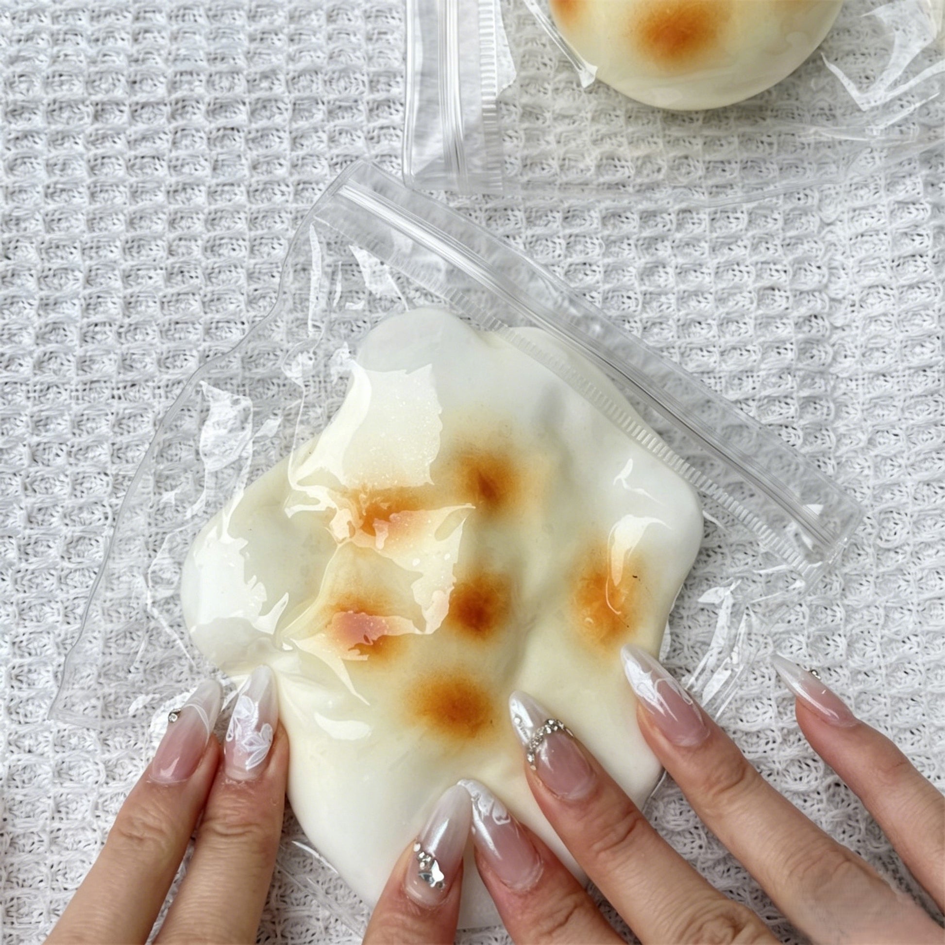 "Multiple realistic grilled rice cake squishy toys displayed in bulk"