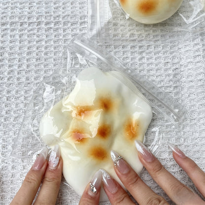 "Multiple realistic grilled rice cake squishy toys displayed in bulk"