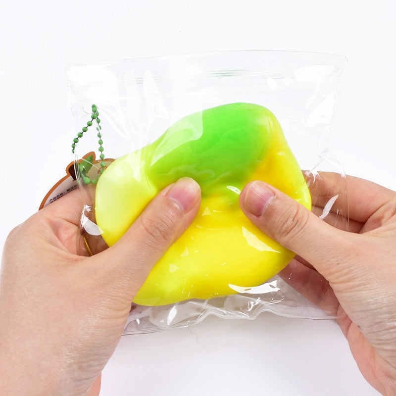 "Individually packaged fluid mango squishy toy with gradient green-yellow color"