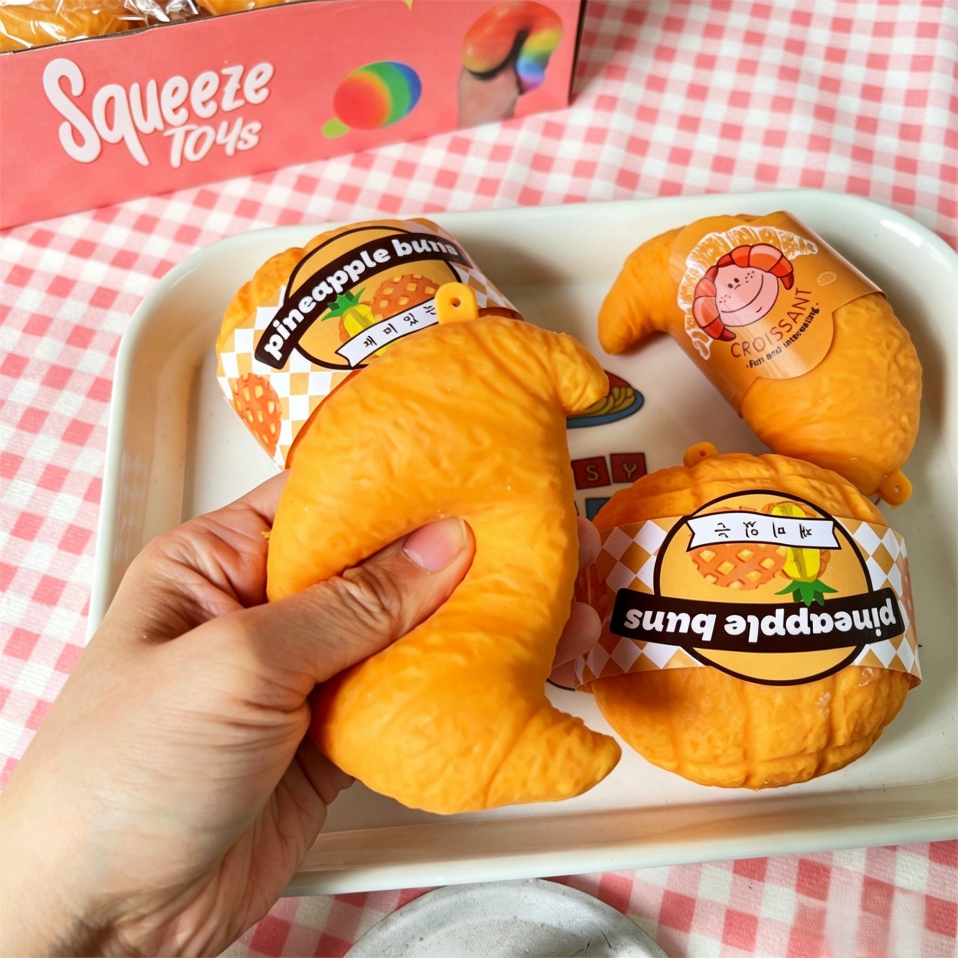 "Individually packaged bread squishy toys arranged on a tray"