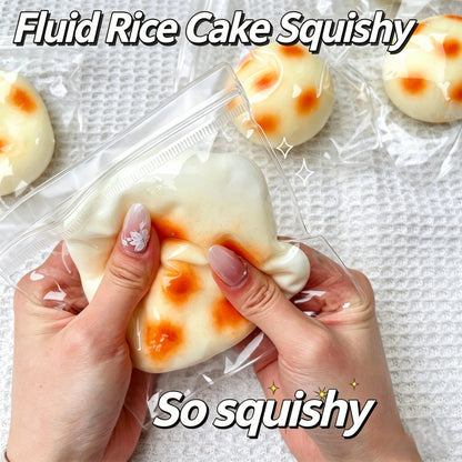 "Hand squeezing fluid rice cake squeeze toy showing soft and flowing texture"