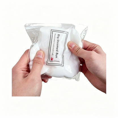 "Hand squeezing soft steamed bun squishy toy showing ultra-soft texture"