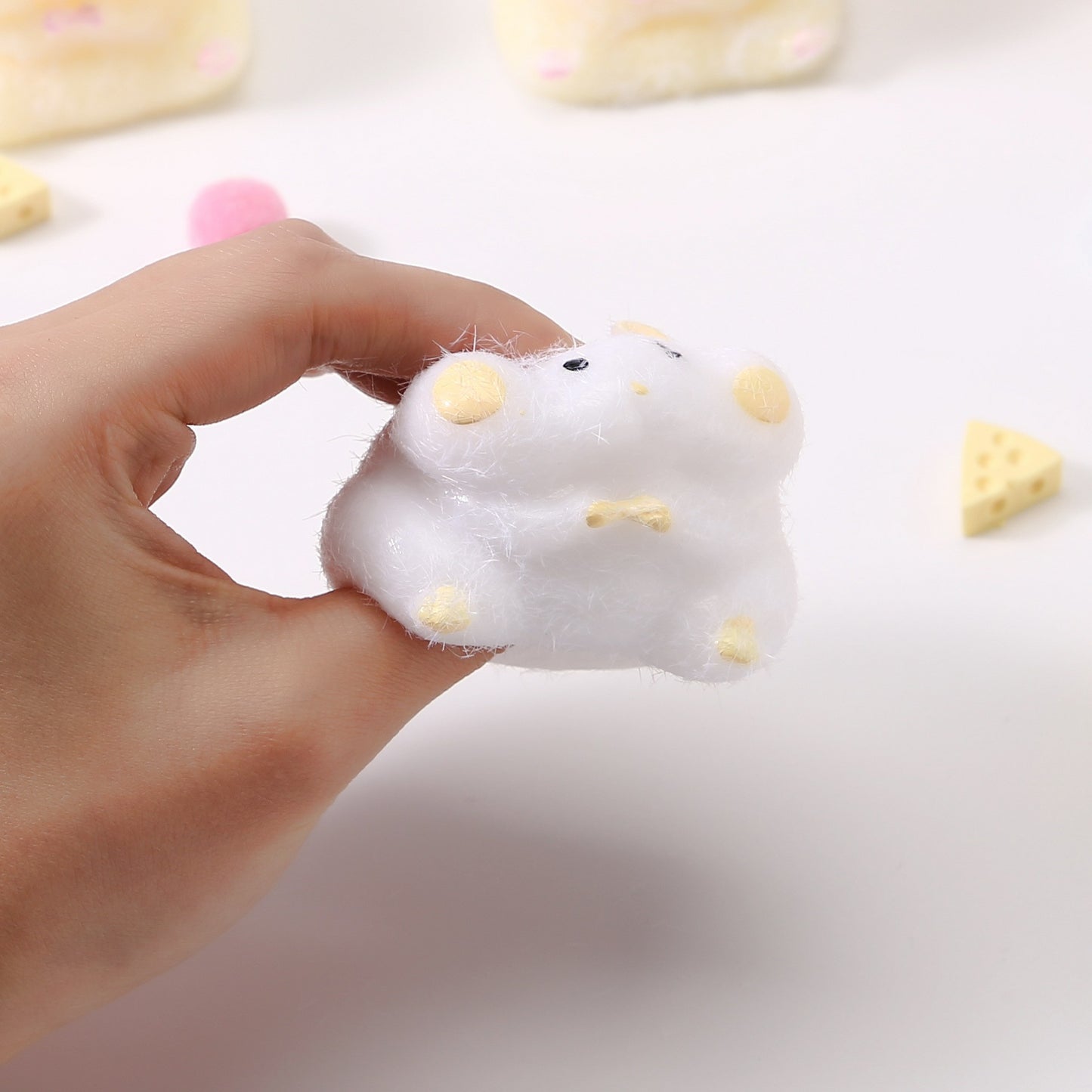 "Hand squeezing soft hamster-shaped squishy toy showing slow rebound effect"