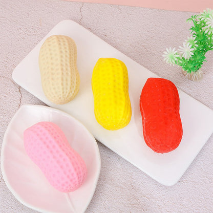 "Hand squeezing soft peanut-shaped squishy toy showing slow rebound effect"