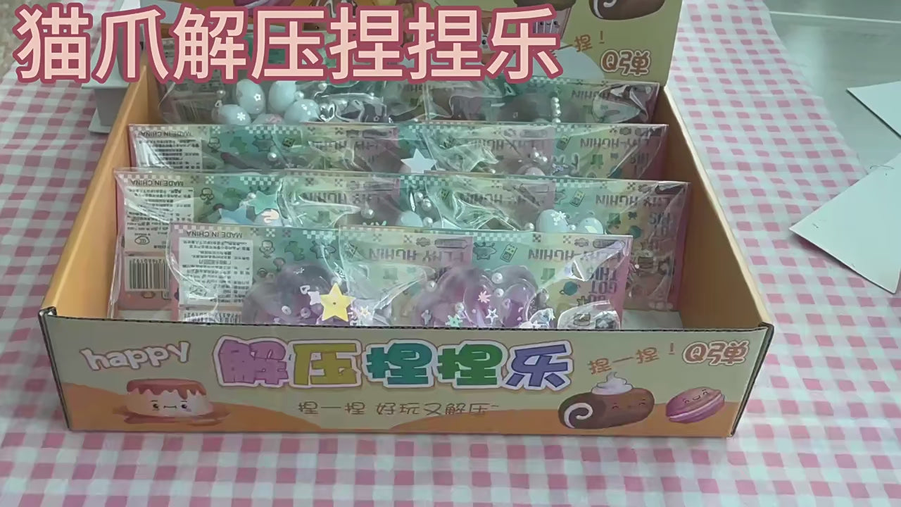 "Hand pinching glitter cat paw squeeze toy with floating star sequin and pearl inside"