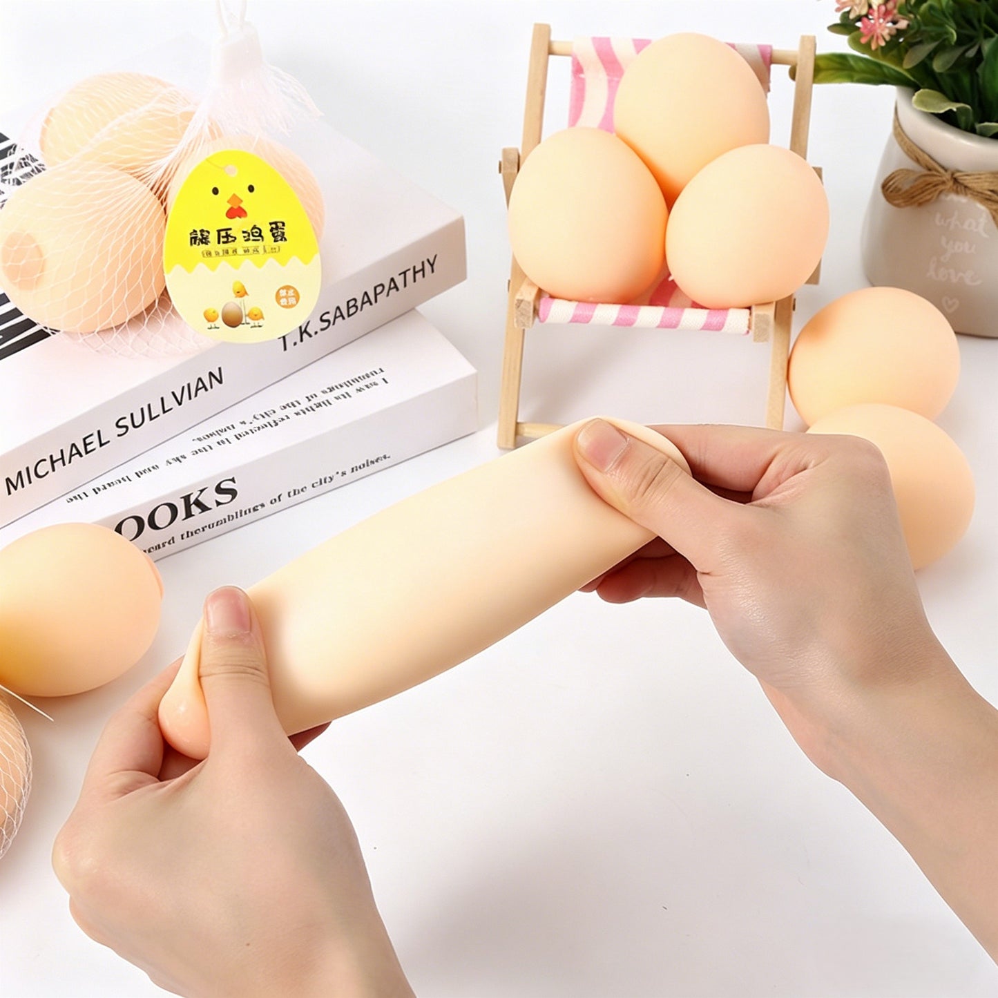 "Lifelike egg squeeze toy displayed in a mesh bag with chick tag"