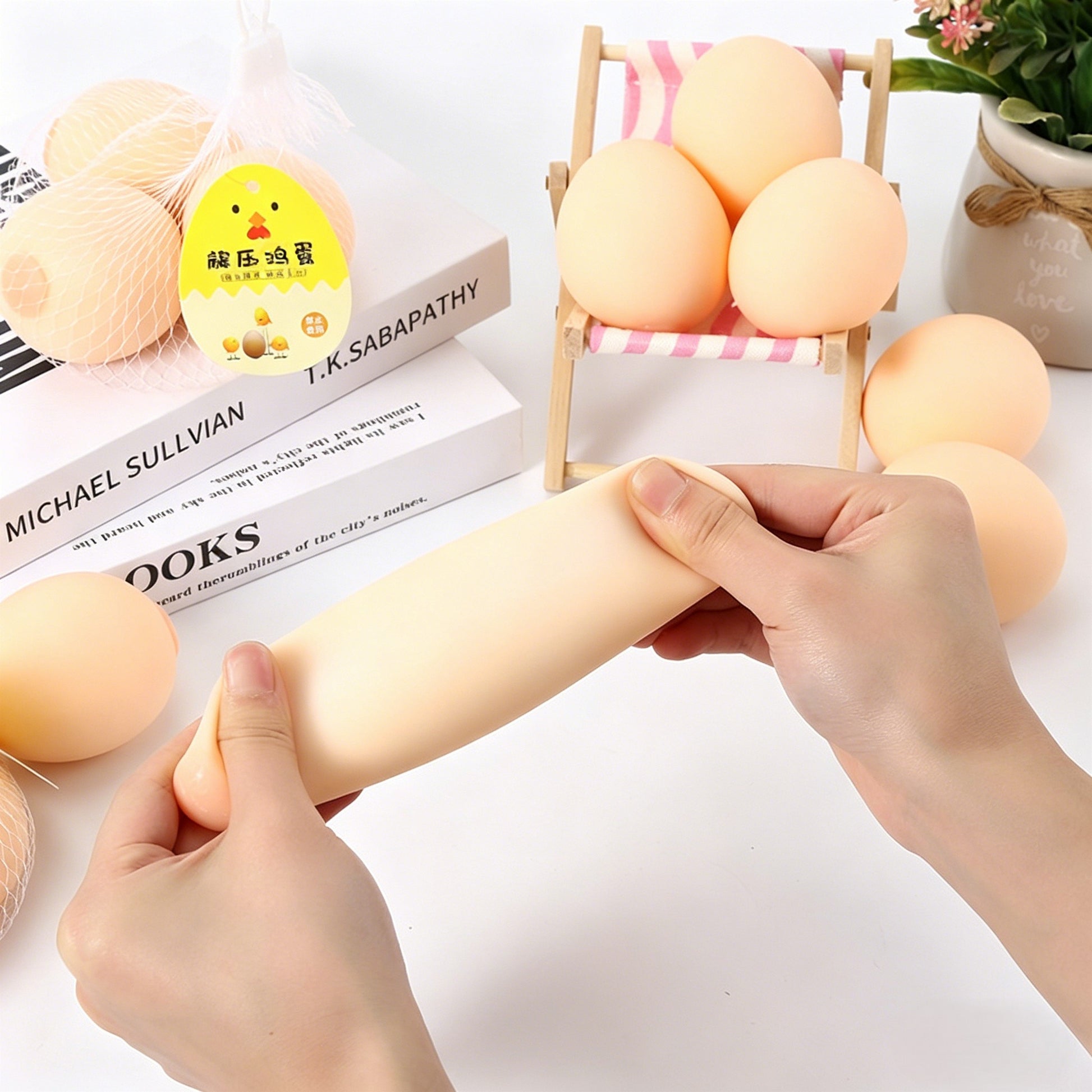 "Lifelike egg squeeze toy displayed in a mesh bag with chick tag"