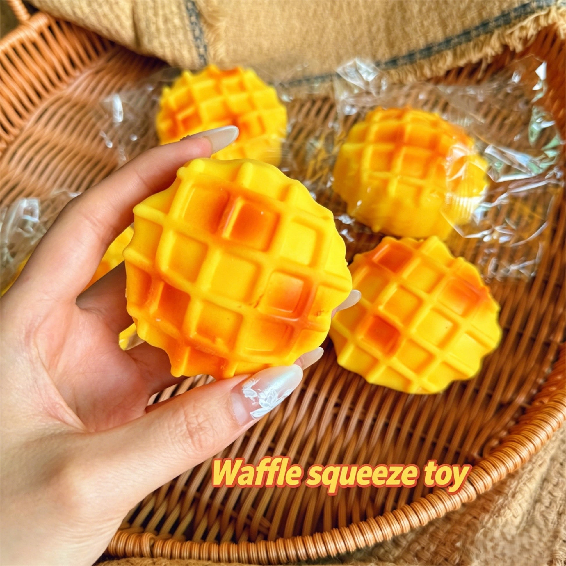 "Multiple waffle squishy toys displayed in a wicker basket"
