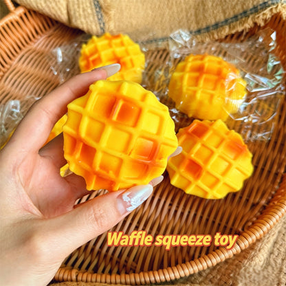 "Multiple waffle squishy toys displayed in a wicker basket"