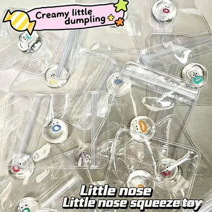 "Hand holding individually packed transparent mini nose squishy toy with bead chain"