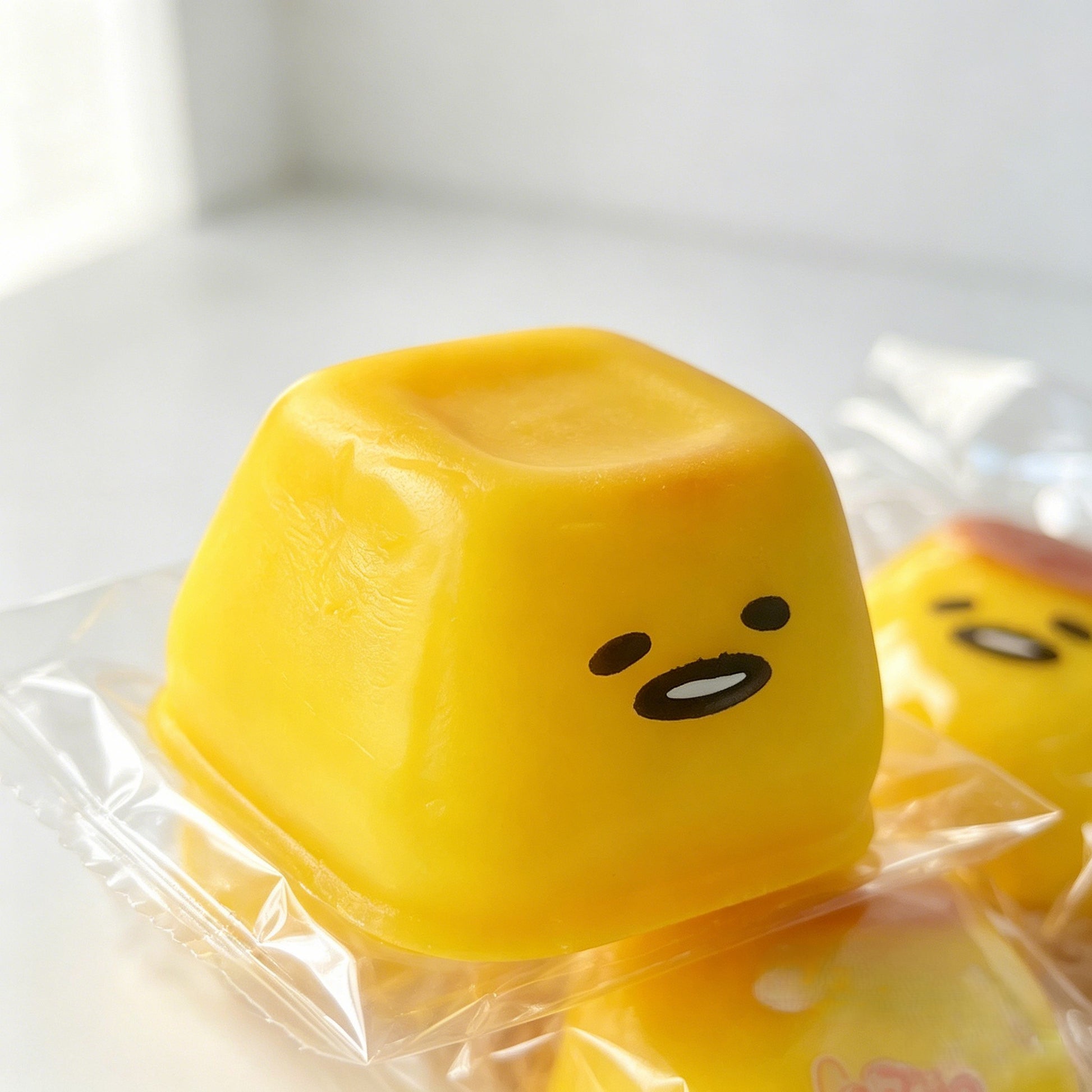 "Hand squeezing soft pudding squishy toy showing slow rebound effect"