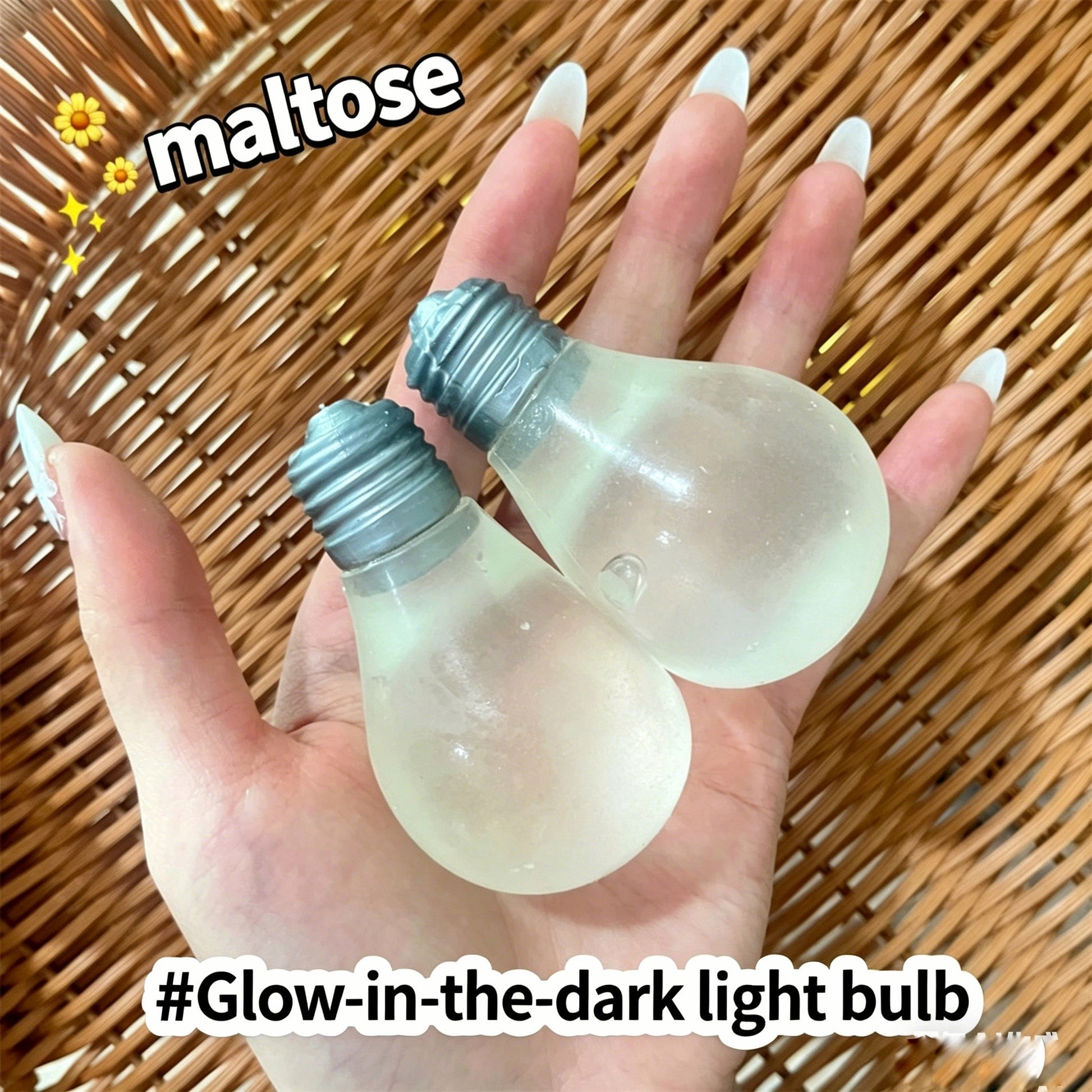 "Hand holding two light bulb-shaped squishy toys daytime and glowing effect"